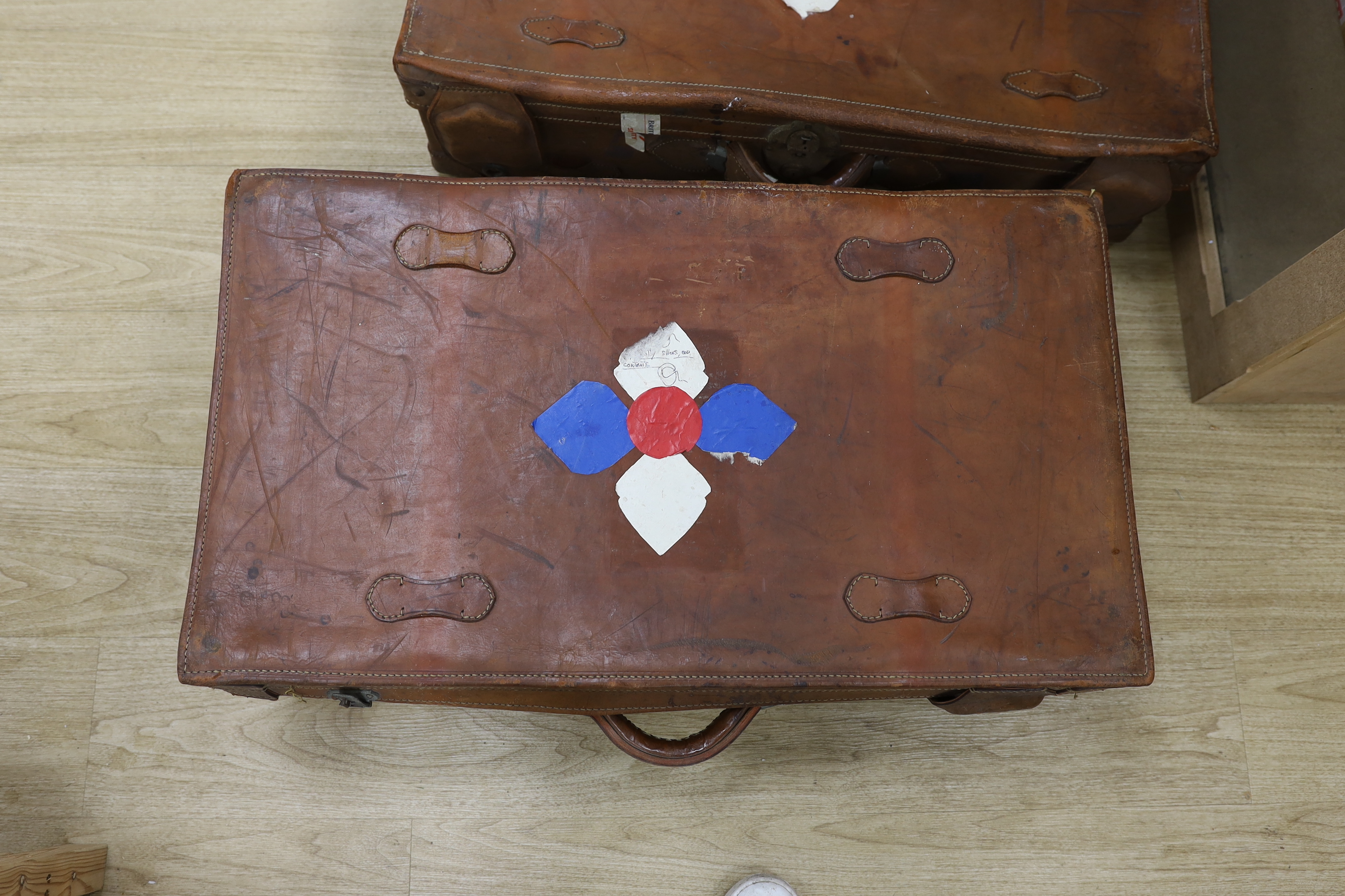 A pair of large brown leather suitcases, 81cm wide, 47cm deep